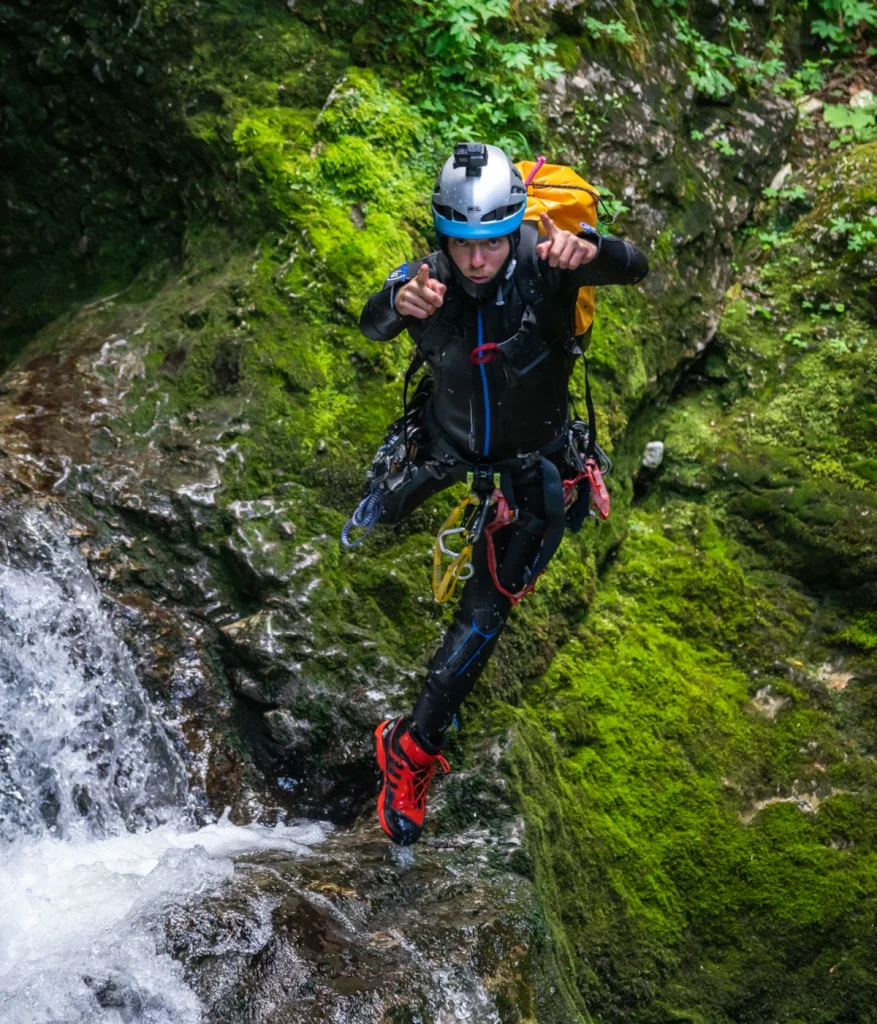 Canyoner jumps from waterfall in Grmecica Canyon Slovenia