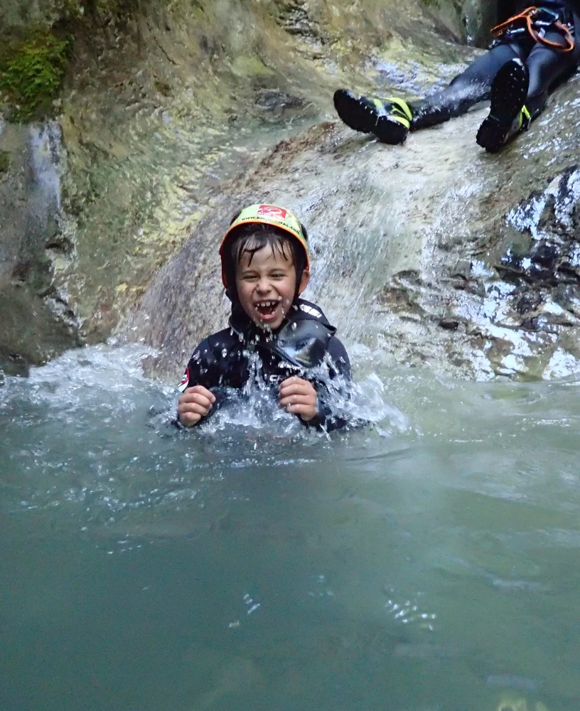 Happy canyoning participant in natural pool at Jerečica Canyon