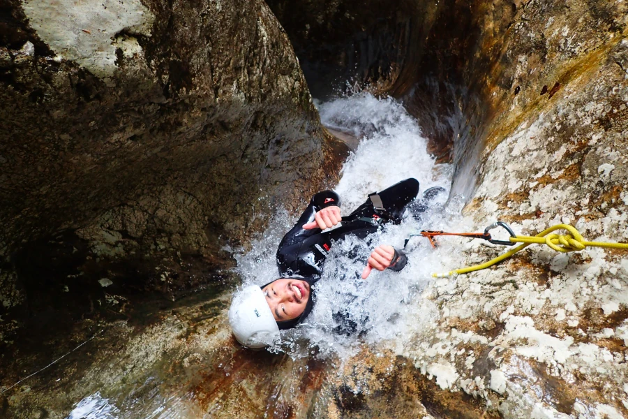 Guest descending waterfall slide during Jerečica Canyon tour