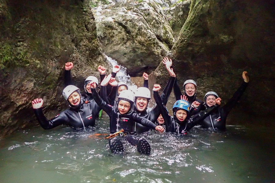 Group enjoying canyoning adventure in Jerečica Canyon pool